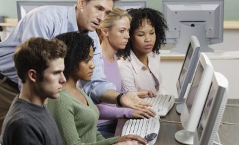 Instructor with Students in Computer Lab --- Image by © Royalty-Free/Corbis